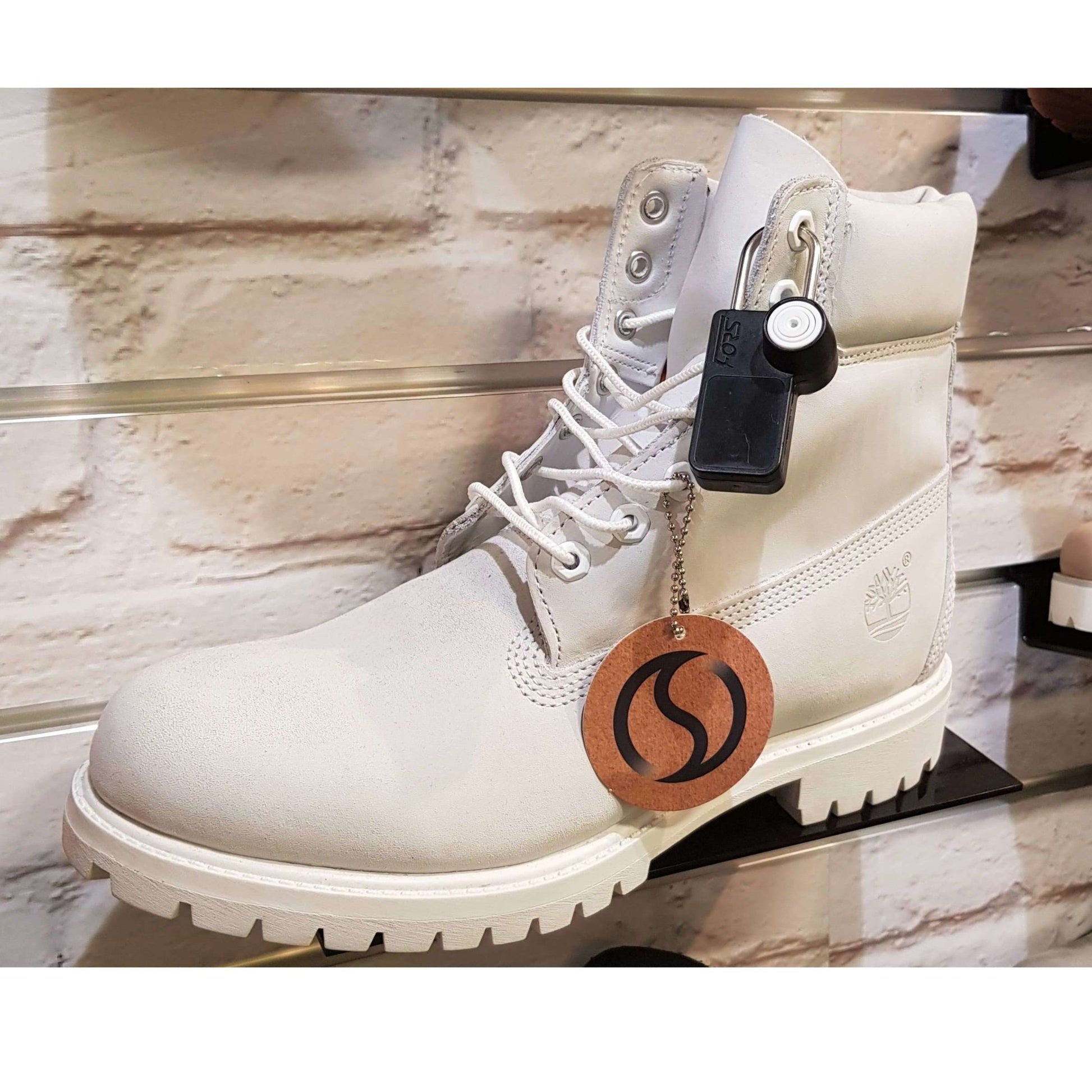Forstag Padlock Tag securely attached to a shoe for discreet retail protection.