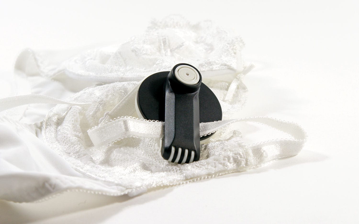 Forstag Round Clamp Tag securely attached to a bra strap without damaging the fabric.
