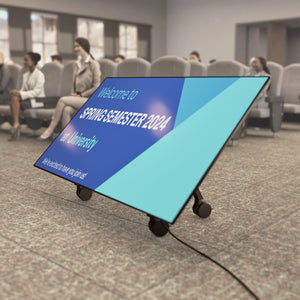Front view of Confidence Stand showing sleek, powder-coated steel frame with VESA mounting for 50–75 inch screens.