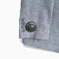 Side view of Mitag MiTag 50 anti-theft tag on clothing, showing a low-profile, tamper-resistant design.