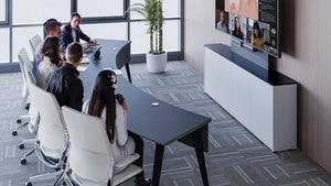 Salamander Arc Table in modern meeting room, curved design, seats 10 with integrated tech.