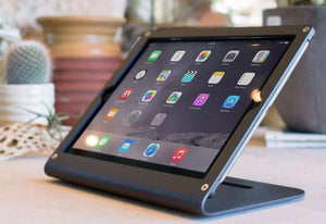 Side view of Heckler Stand Prime showing all-steel construction and snug tablet fit for professional displays.