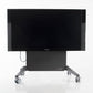 Wall stand installed in a conference room, demonstrating ergonomic screen positioning and space-saving benefits.